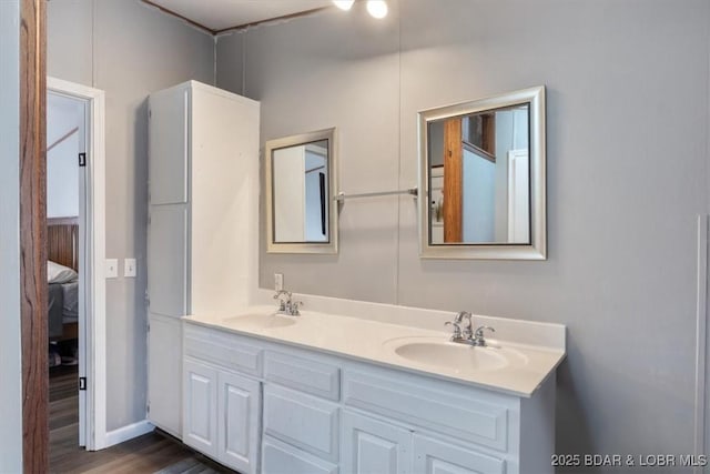 full bath with wood finished floors, a sink, and double vanity