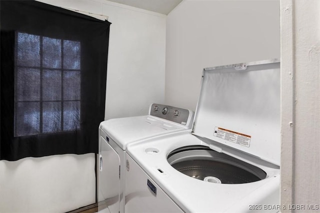 washroom featuring laundry area and washer and clothes dryer