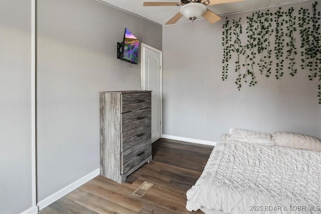 bedroom featuring baseboards, visible vents, ceiling fan, and dark wood-type flooring