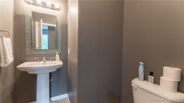 bathroom with toilet and a sink