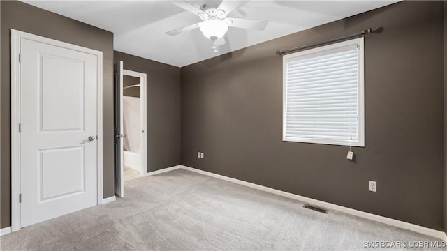 unfurnished bedroom with light carpet, ceiling fan, visible vents, and baseboards