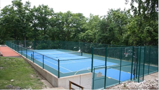 view of tennis court with fence