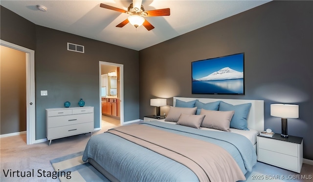 bedroom with baseboards, visible vents, light colored carpet, ceiling fan, and ensuite bathroom