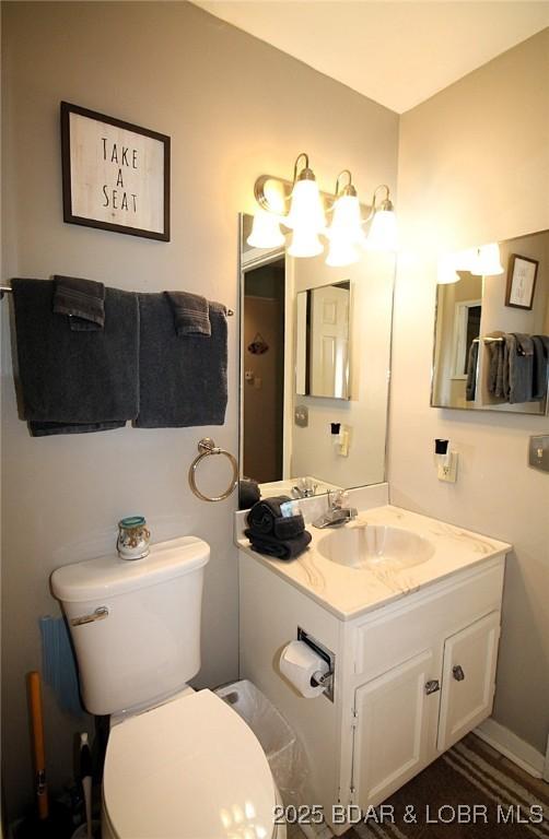 bathroom featuring toilet and vanity