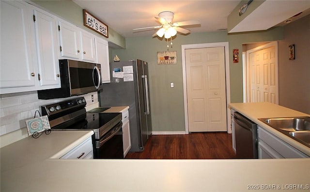 kitchen with light countertops, appliances with stainless steel finishes, a ceiling fan, and white cabinets