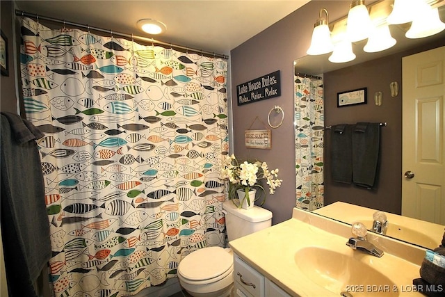 bathroom featuring toilet, a shower with shower curtain, and vanity