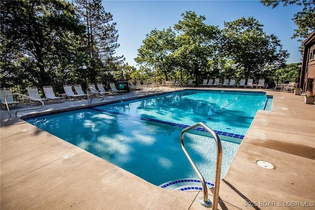 community pool featuring a patio and fence