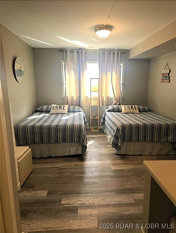 bedroom featuring dark wood finished floors