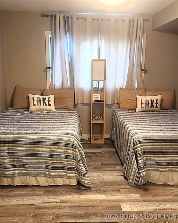 bedroom with wood finished floors