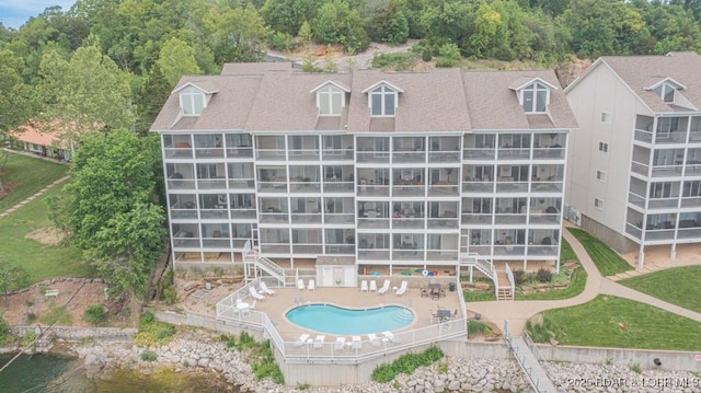 view of building exterior featuring a community pool