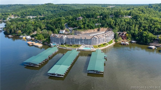 drone / aerial view featuring a water view and a view of trees