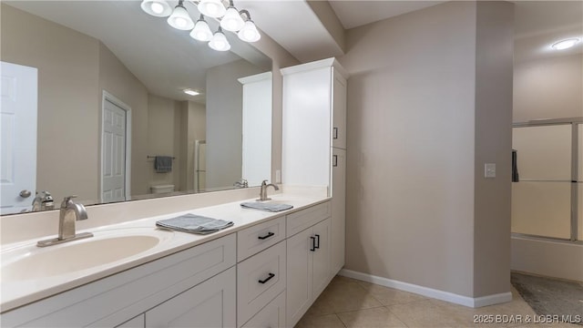 full bath featuring toilet, baseboards, a sink, and tile patterned floors