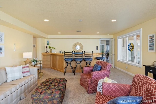 living room with a wealth of natural light, recessed lighting, light carpet, and baseboards