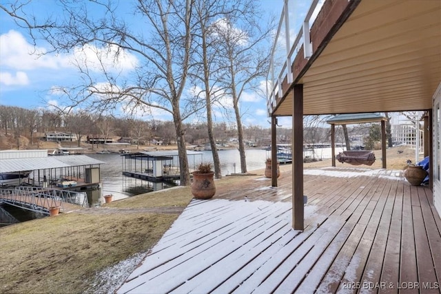 wooden deck featuring a water view and a boat dock