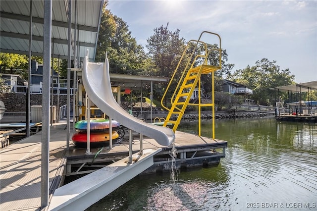 view of play area featuring a water view and a floating dock