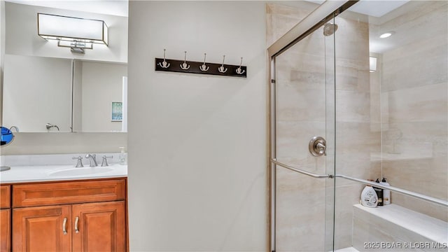 bathroom featuring a shower stall and vanity