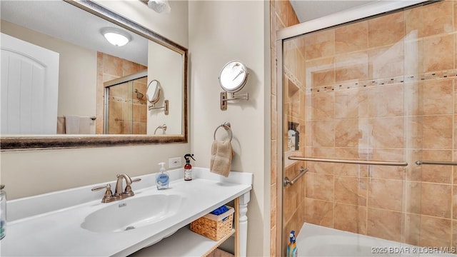 bathroom featuring a tile shower and a sink