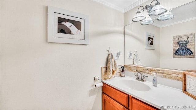 bathroom featuring an inviting chandelier, vanity, and crown molding