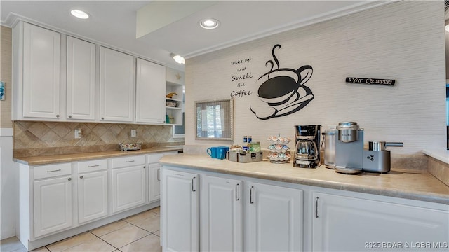 kitchen with light tile patterned flooring, recessed lighting, white cabinets, light countertops, and backsplash