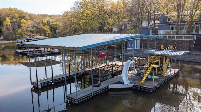 dock area with a water view and boat lift