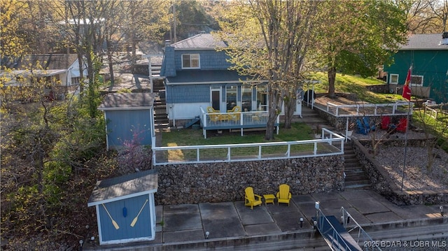 exterior space with a patio area, stairs, and a deck