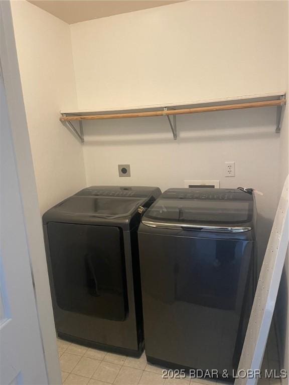 laundry area with light tile patterned floors, laundry area, and washer and dryer