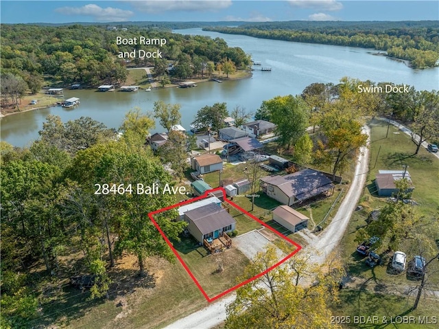 birds eye view of property with a water view and a forest view