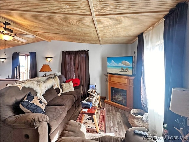 living room with a fireplace, wood finished floors, wood ceiling, a ceiling fan, and vaulted ceiling