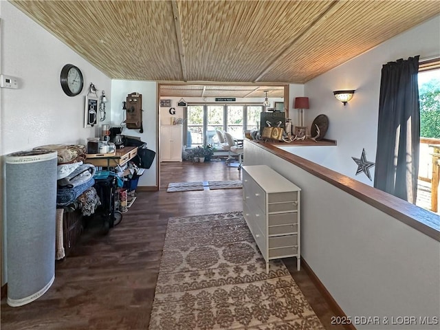 hall featuring wood ceiling, baseboards, and dark wood finished floors