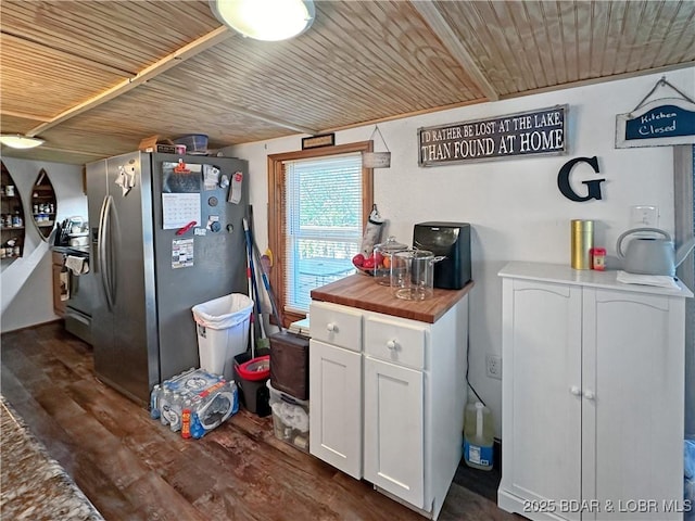 kitchen with butcher block countertops, wood ceiling, white cabinets, stainless steel fridge with ice dispenser, and dark wood-style floors