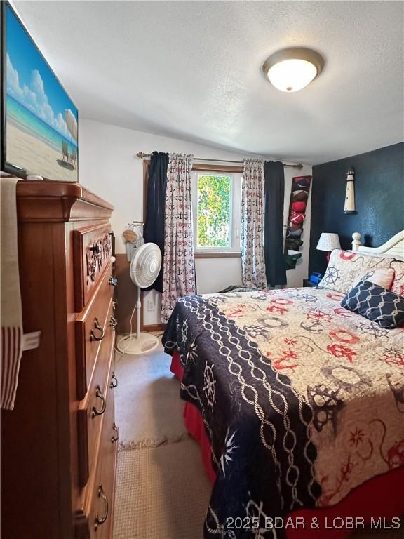 carpeted bedroom featuring a textured ceiling