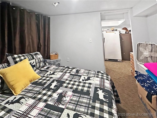 bedroom featuring carpet and freestanding refrigerator