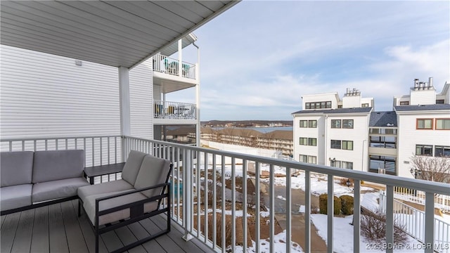 snow covered back of property featuring outdoor lounge area