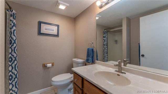 bathroom with curtained shower, toilet, vanity, tile patterned flooring, and baseboards