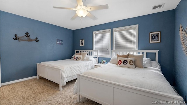 bedroom featuring a ceiling fan, visible vents, light carpet, and baseboards