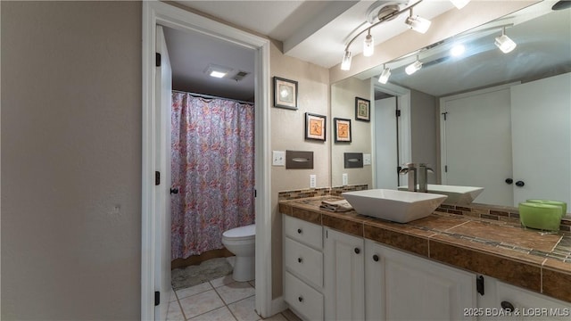 full bathroom with tile patterned flooring, vanity, and toilet