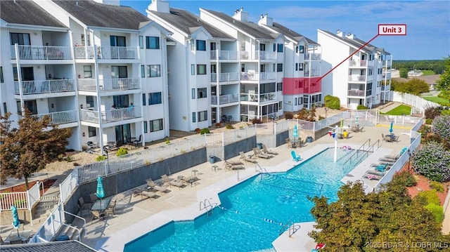 pool featuring a patio area and fence