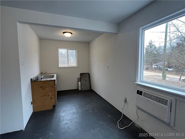 interior space with an AC wall unit and a sink