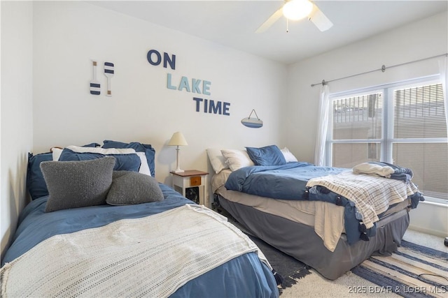 bedroom featuring a ceiling fan and carpet