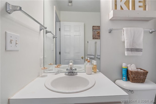 bathroom with toilet and vanity