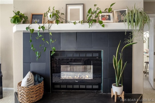 room details featuring a tile fireplace