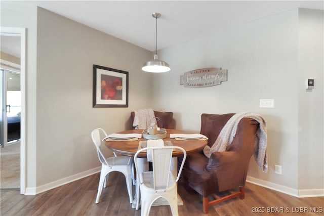 dining room with baseboards and wood finished floors