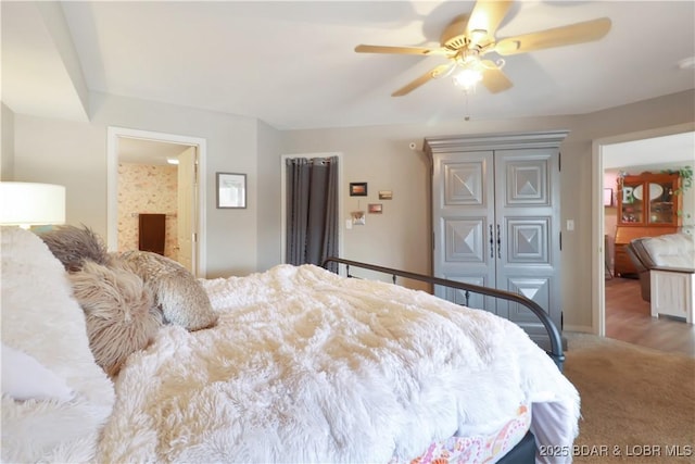 bedroom featuring ceiling fan, carpet flooring, and ensuite bathroom