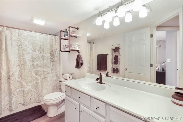 full bathroom featuring toilet, vanity, and a shower with curtain