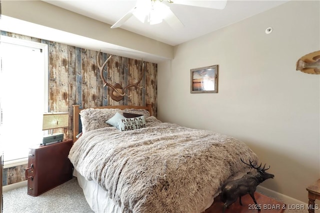 carpeted bedroom with ceiling fan and baseboards