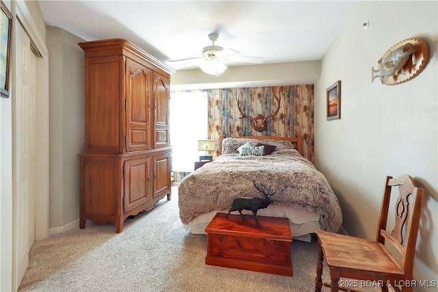 bedroom featuring a ceiling fan and light colored carpet