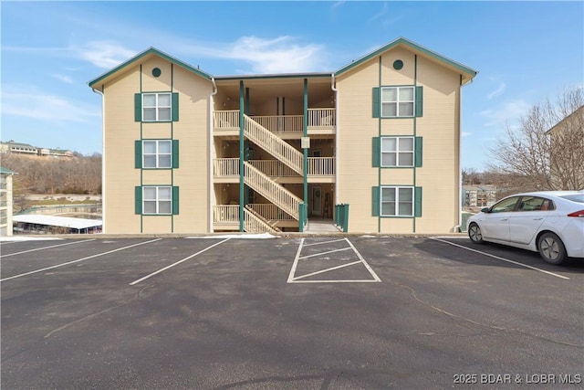 view of building exterior featuring uncovered parking