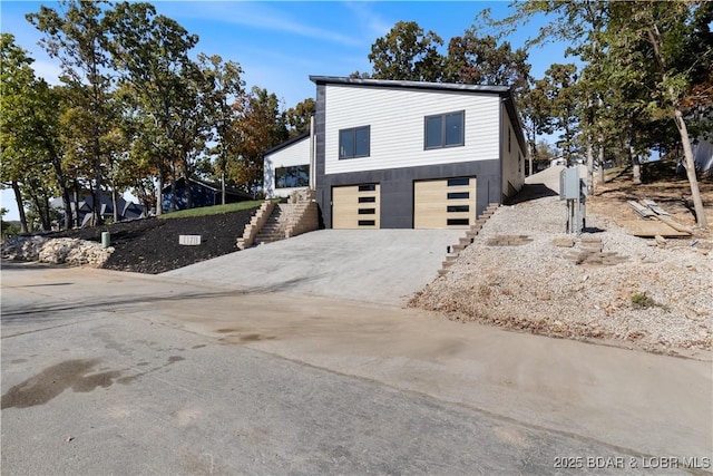 exterior space with concrete driveway and an attached garage