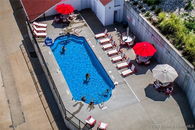 pool featuring a patio area and fence