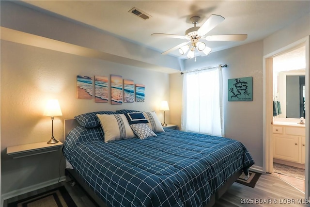 bedroom with baseboards, visible vents, ceiling fan, and wood finished floors